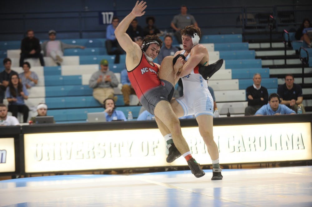 UNC redshirt senior Cory Daniel takes down NC State's Colin Lawler on Friday, Feb. 15, 2019. NC State won the wrestling match 20-14. 