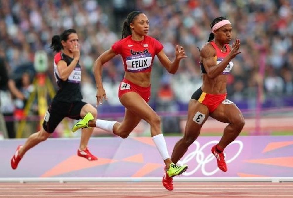 LONDON, ENGLAND - AUGUST 03:  (L-R) Allyson Felix of the United States and Toea Wisil of Papua New Guinea competes in the  Women's 100m Round 1 Heats on Day 7 of the London 2012 Olympic Games at Olympic Stadium on August 3, 2012 in London, England.  (Photo by Cameron Spencer/Getty Images)