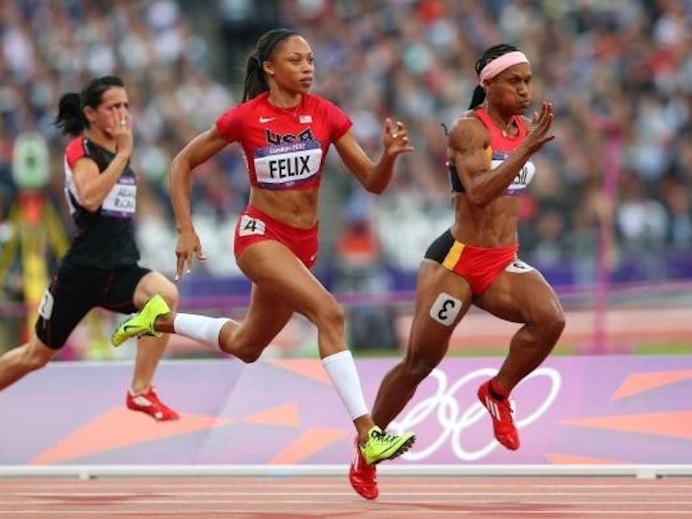 LONDON, ENGLAND - AUGUST 03:  (L-R) Allyson Felix of the United States and Toea Wisil of Papua New Guinea competes in the  Women's 100m Round 1 Heats on Day 7 of the London 2012 Olympic Games at Olympic Stadium on August 3, 2012 in London, England.  (Photo by Cameron Spencer/Getty Images)