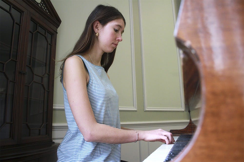 <p>Junior geography and psychology major Emma Armstrong-Carter plays the piano in McIver Residence Hall. McIver is one of 11 residence halls on campus with a piano.</p>