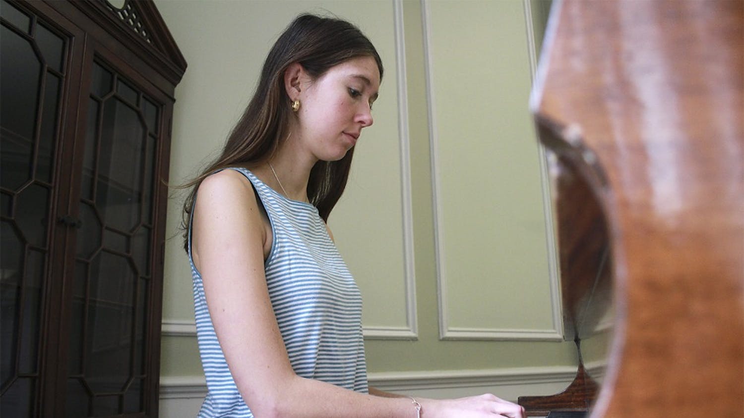 Junior geography and psychology major Emma Armstrong-Carter plays the piano in McIver Residence Hall. McIver is one of 11 residence halls on campus with a piano.
