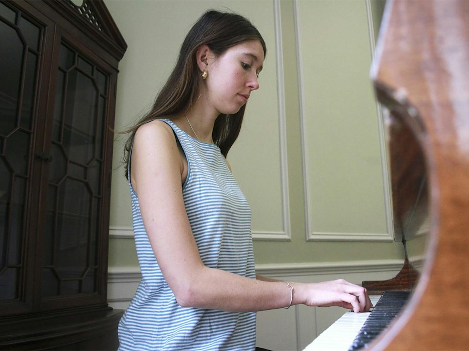 Junior geography and psychology major Emma Armstrong-Carter plays the piano in McIver Residence Hall. McIver is one of 11 residence halls on campus with a piano.