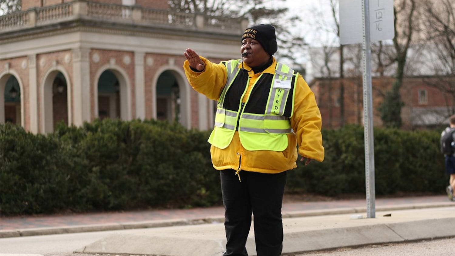 Joann Isom direct pedestrian and vehicle traffic every morning in front of the bell tower to help students get safely to and from class.