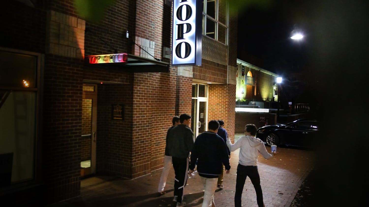 UNC students walk pass Top Of The Hill restaurant and brewery in Chapel Hill Monday night. &nbsp;