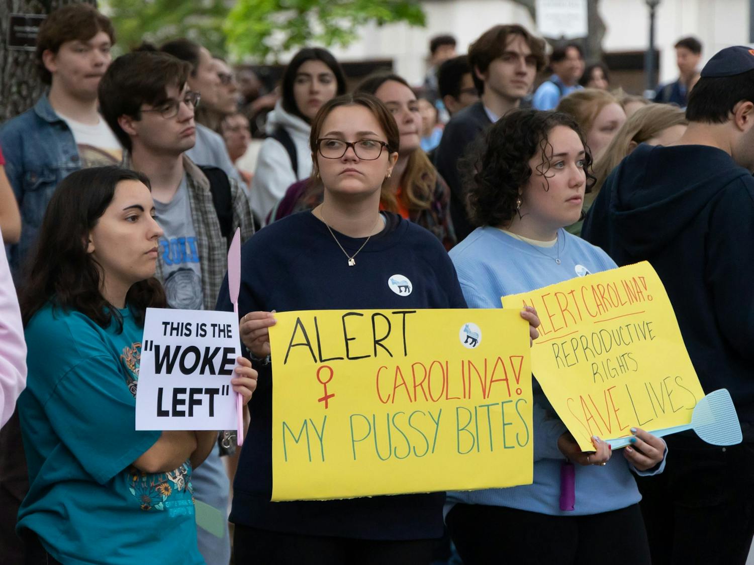 UNC students hold signs to protest the visitation of former Vice President Mike Pence in the Pit on April 26, 2023, in Chapel Hill, N.C.