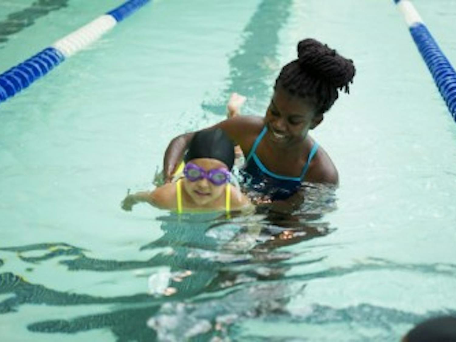 Chapel Hill volunteer, Kennedy Parkins, helps&nbsp;child swim down the lane during a lesson&nbsp;through Dive In last year at the Bowman-Gray Pool on campus.&nbsp;
&nbsp;Photos by Andrew Lee.&nbsp;Photos courtesy of Lexi Hawks, co-president of Dive In: Chapel Hill.&nbsp;&nbsp;