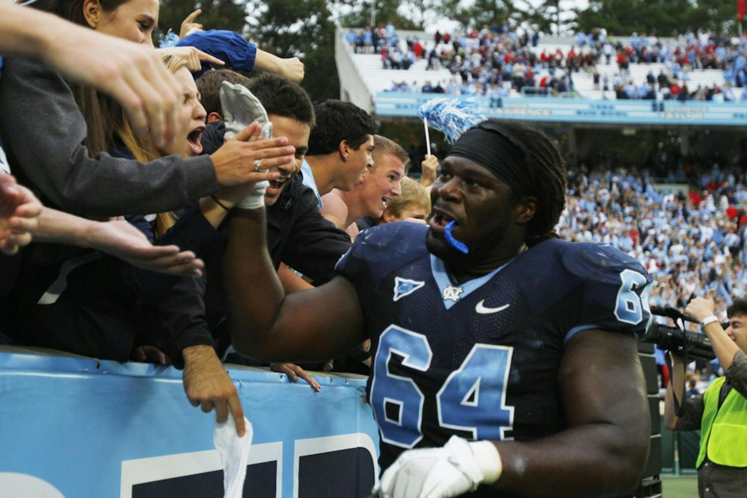 	Jonathan Cooper greets fans after a game in UNC’s Kenan Stadium. 