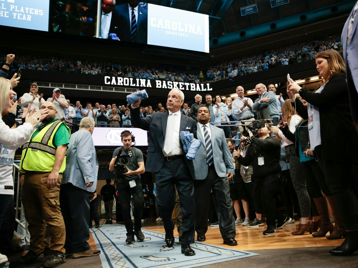 Head Coach Roy Williams prepares to toss t-shirts into the crowd ahead of a game against Duke in the Smith Center on Saturday, Feb. 8, 2020. The Tar Heels lost to the Blue Devils 98-96.