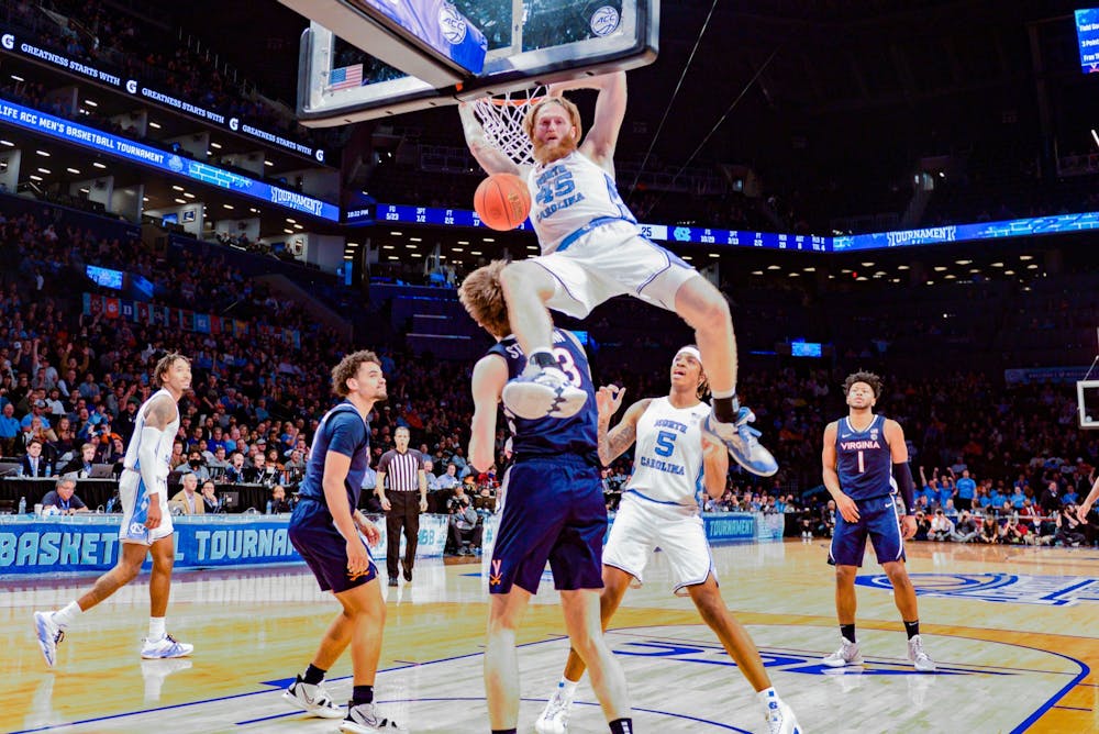 Graduate transfer forward Brady Manek (35) dunks the ball during the quarterfinals of the ACC tournament against Virginia at the Barclays Center in Brooklyn on March 10, 2022. UNC will advance to the semifinals of the tournament after beating Virginia 63-43.