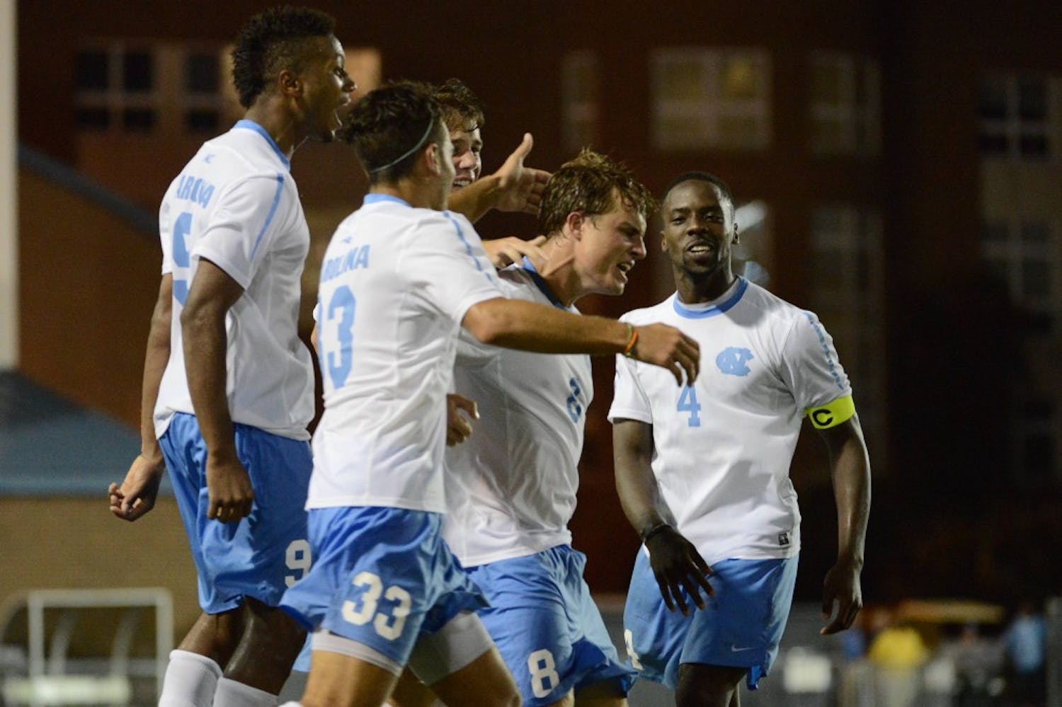 UNC forward Tyler Engel (8) celebrates with teammates after scoring the game winning goal.