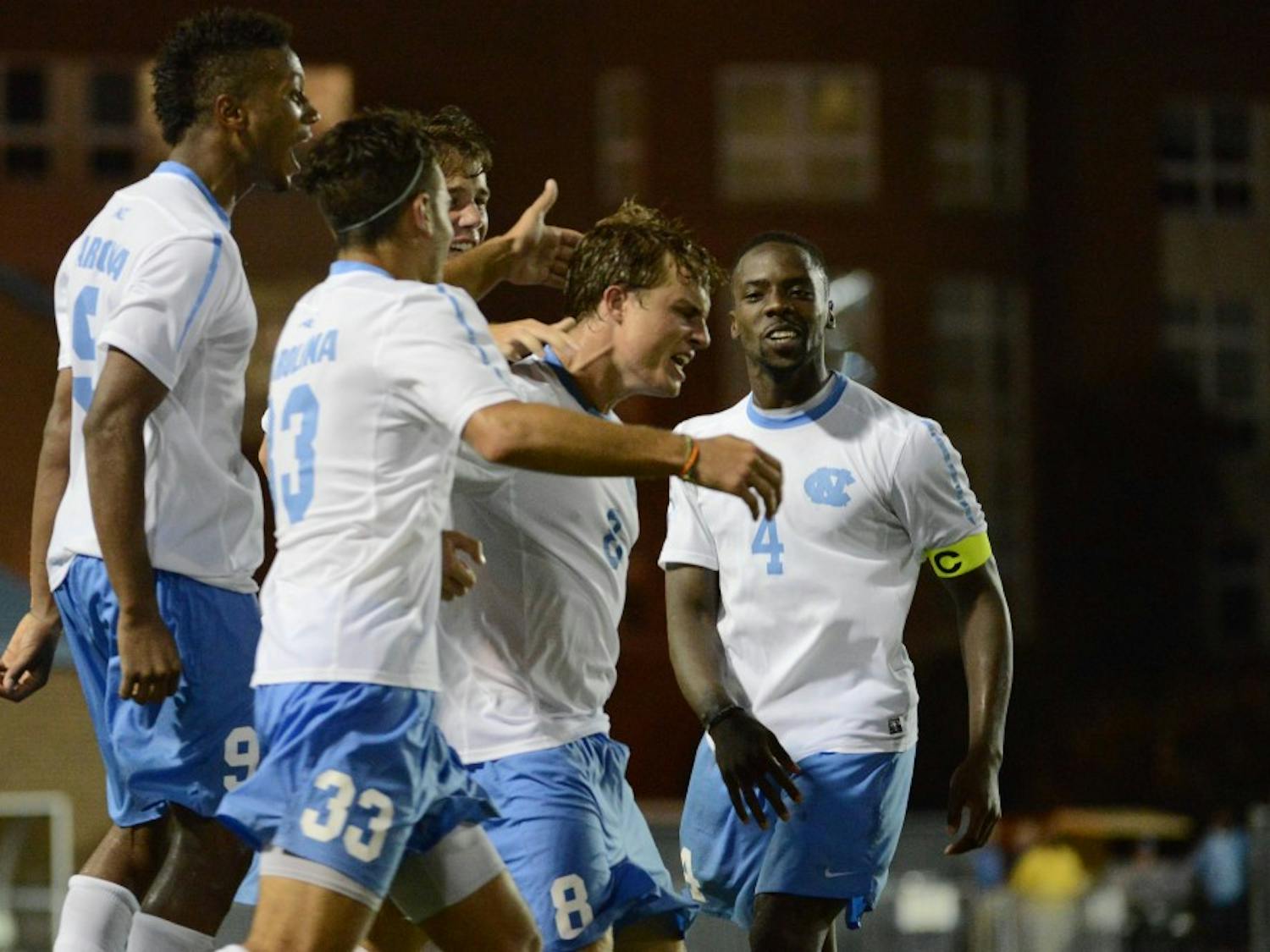 UNC forward Tyler Engel (8) celebrates with teammates after scoring the game winning goal.