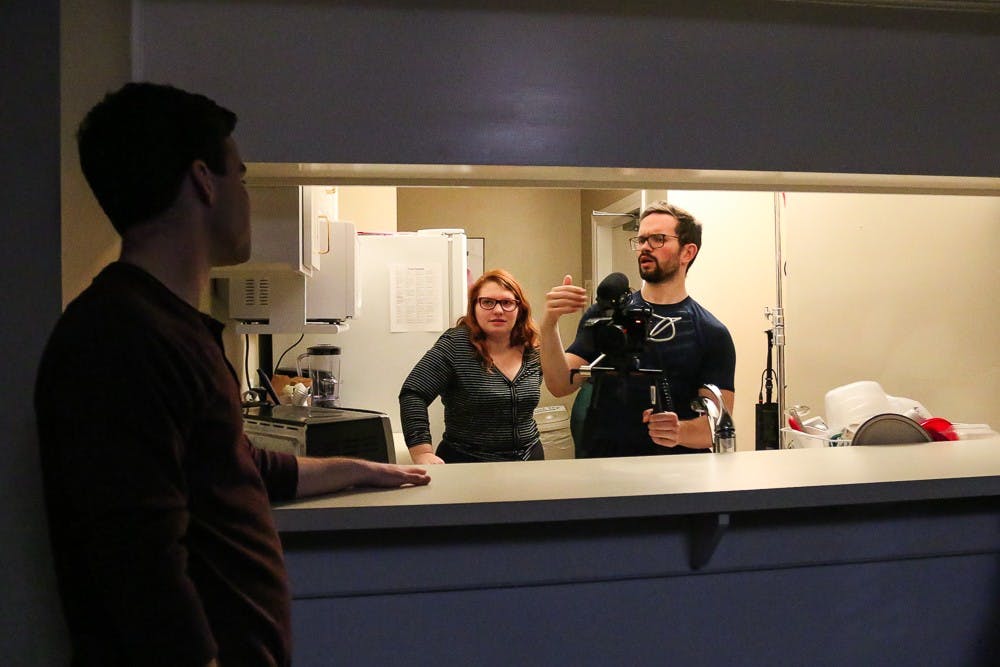 (From left) Junior communication and dramatic arts major Matthew Keith, CFA president junior Julia Stamey, and junior computer science and communications major Michael Sparks discuss a scene on the set of a project on Friday, Feb. 7, 2020.