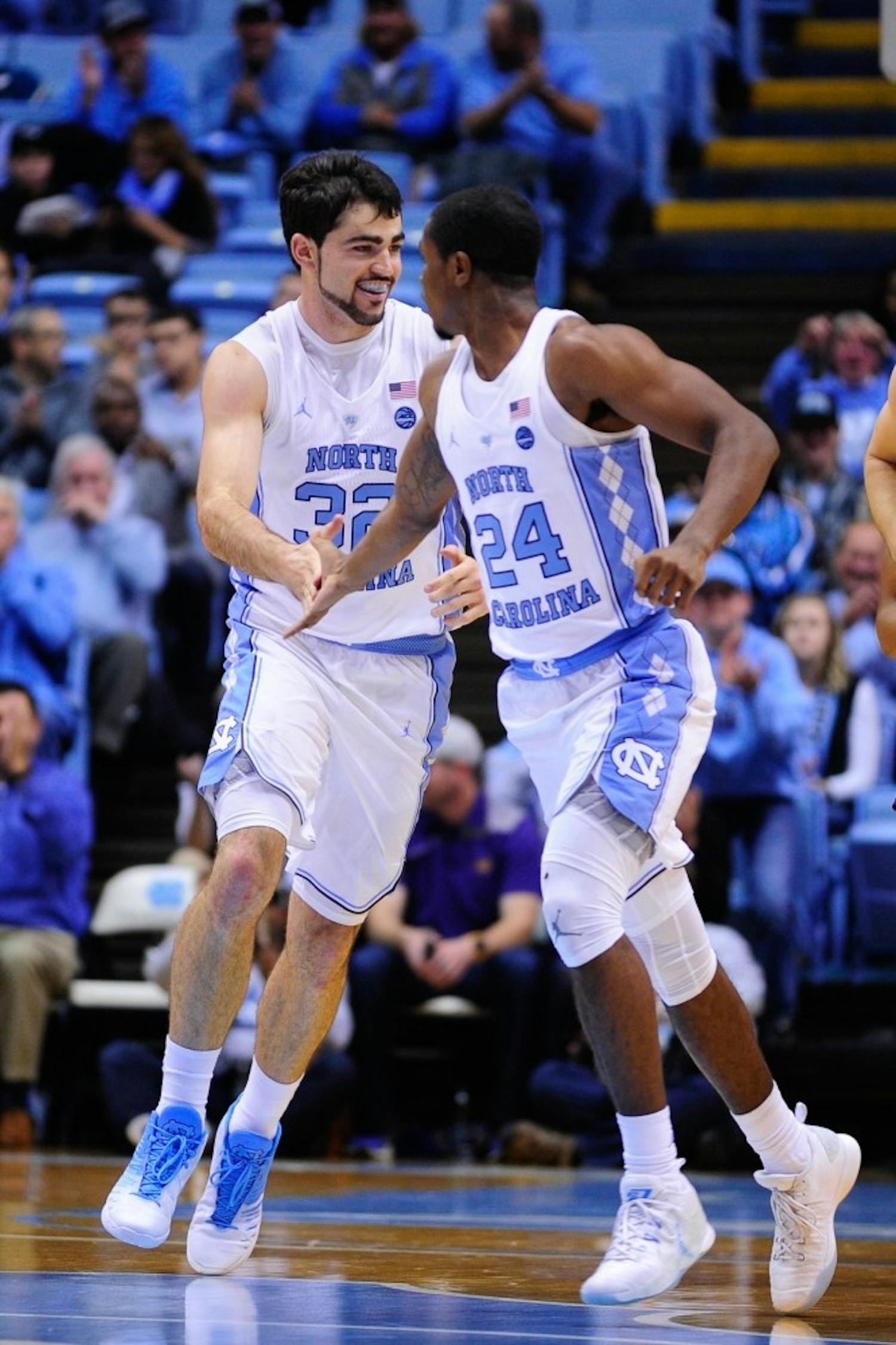 Juniors Luke Maye (32) and Kenny Williams (24) celebrate during the second half against Northern Iowa in an 86-69 victory on Nov. 10.
