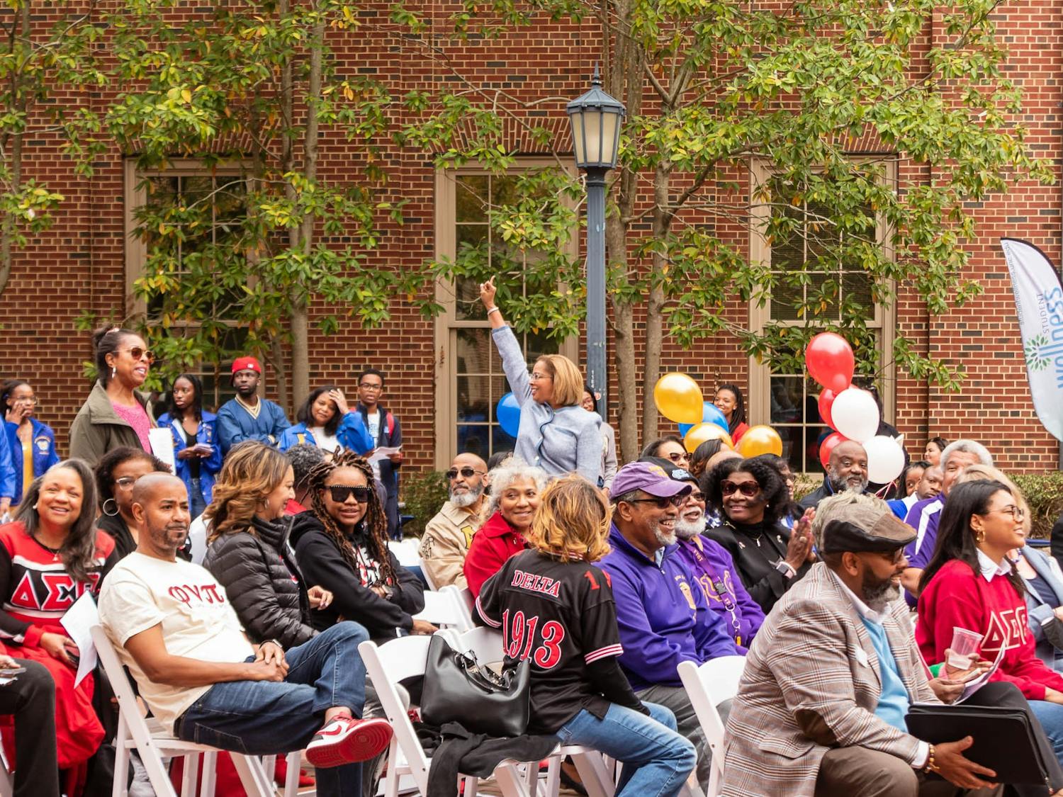 Dozens of people gather in celebration of the opening of the NPHC Legacy Plaza on UNC's campus. The plaza represents the University's nine historically Black fraternities and sororities for their contributions to the campus community.