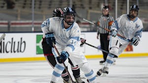 UNC forward Patrick O'Shaughnessy (14) transitions the puck across the rink during the ice hockey game against N.C. State at Carter-Finley Stadium on Monday, Feb. 20, 2023. UNC lost 3-7.