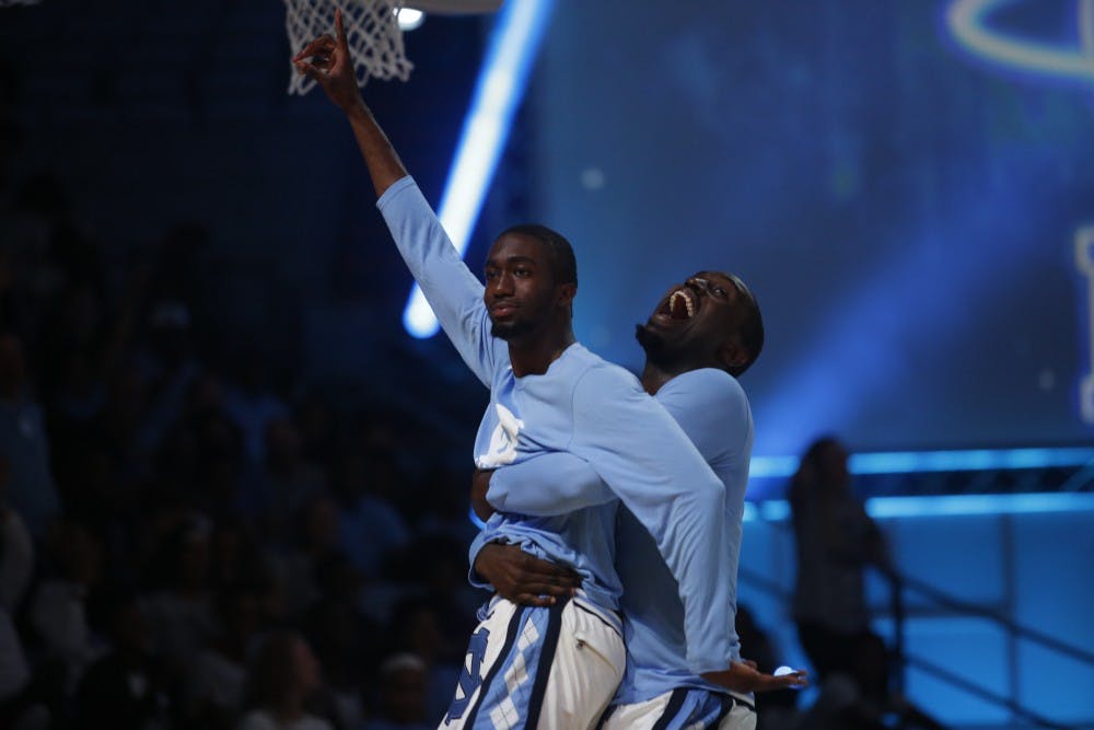 Brandon Robinson celebrates with Theo Pinson after hitting a shot during Late Night With Roy on Friday night.