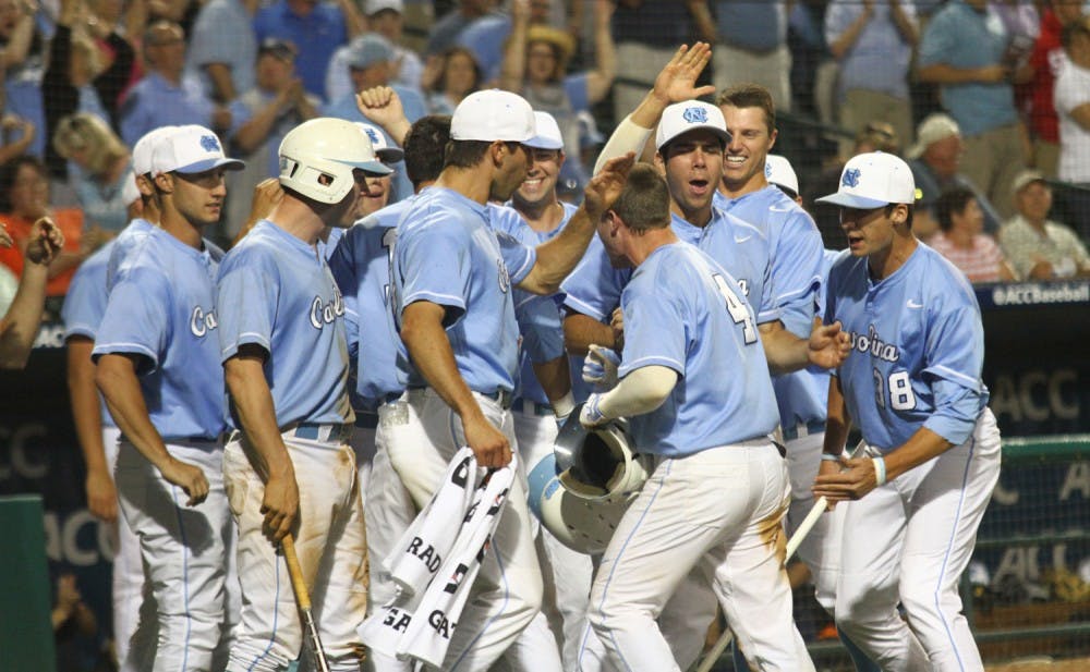 The dugout congratulates Wood Myers (4) as he arrives back to the dugout. UNC baseball was defeated by Virginia 3-2 Friday night in Greensboro in the ACC tournament. 