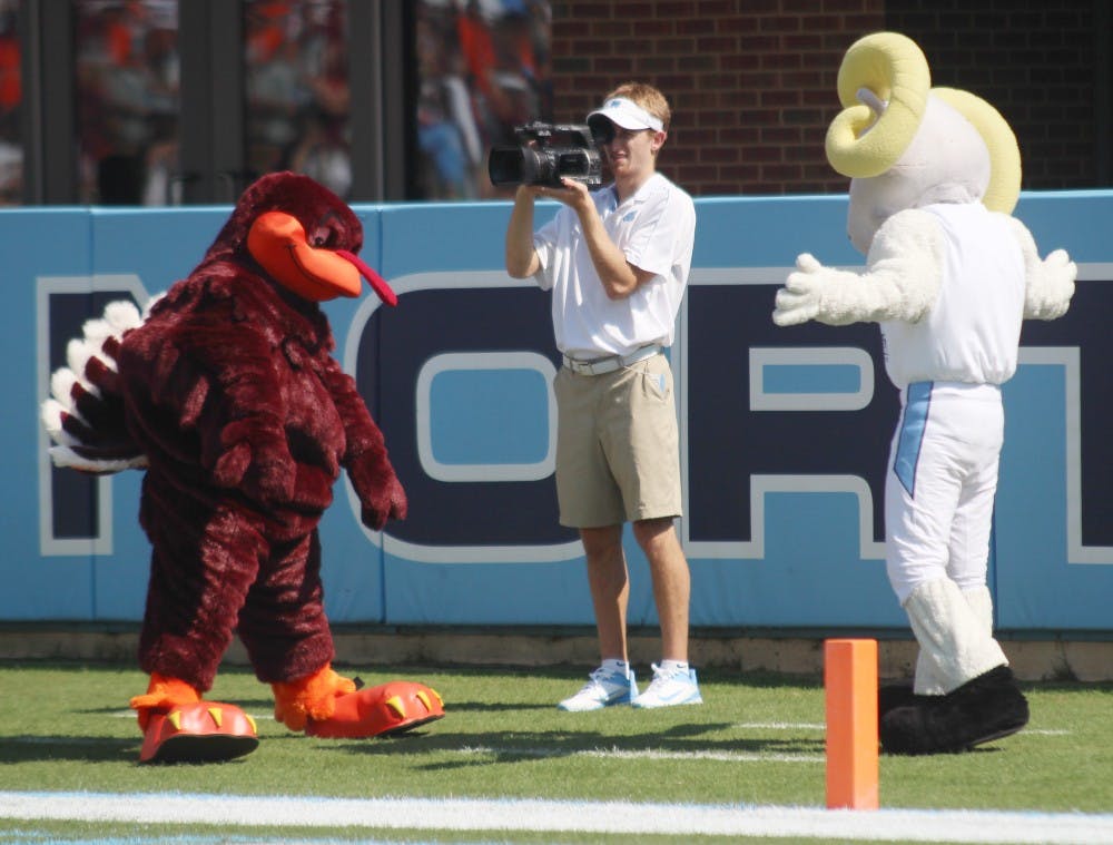 	The UNC and Virgina Tech mascots duke it out in the end-zone at the football game.
