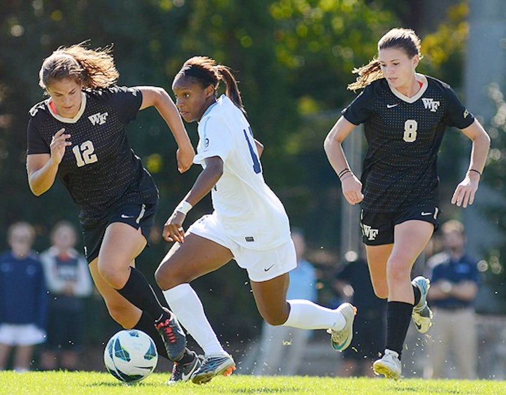 	Junior forward Crystal Dunn, who assisted the Tar Heels’ only goal of the game, evades Wake Forest’s forward Katie Stengel. 