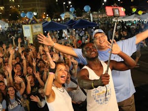 Chancellor Carol Folt (left), Boateng Kubi ,Chair of Carolina Union Board of Directors (center) and Vice Chancellor Winston Crisp (right) take a selfie with students at Fall Fest on Sunday, Aug. 21, 2016.