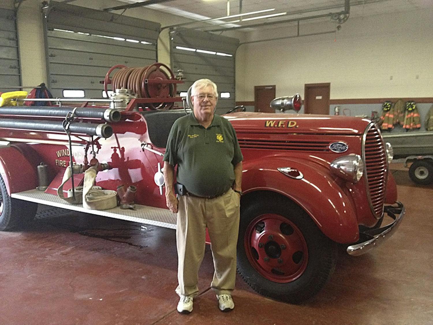 Chief Billy Smithwick&nbsp;stands in front of the fire station's first fire engine from&nbsp;1939.