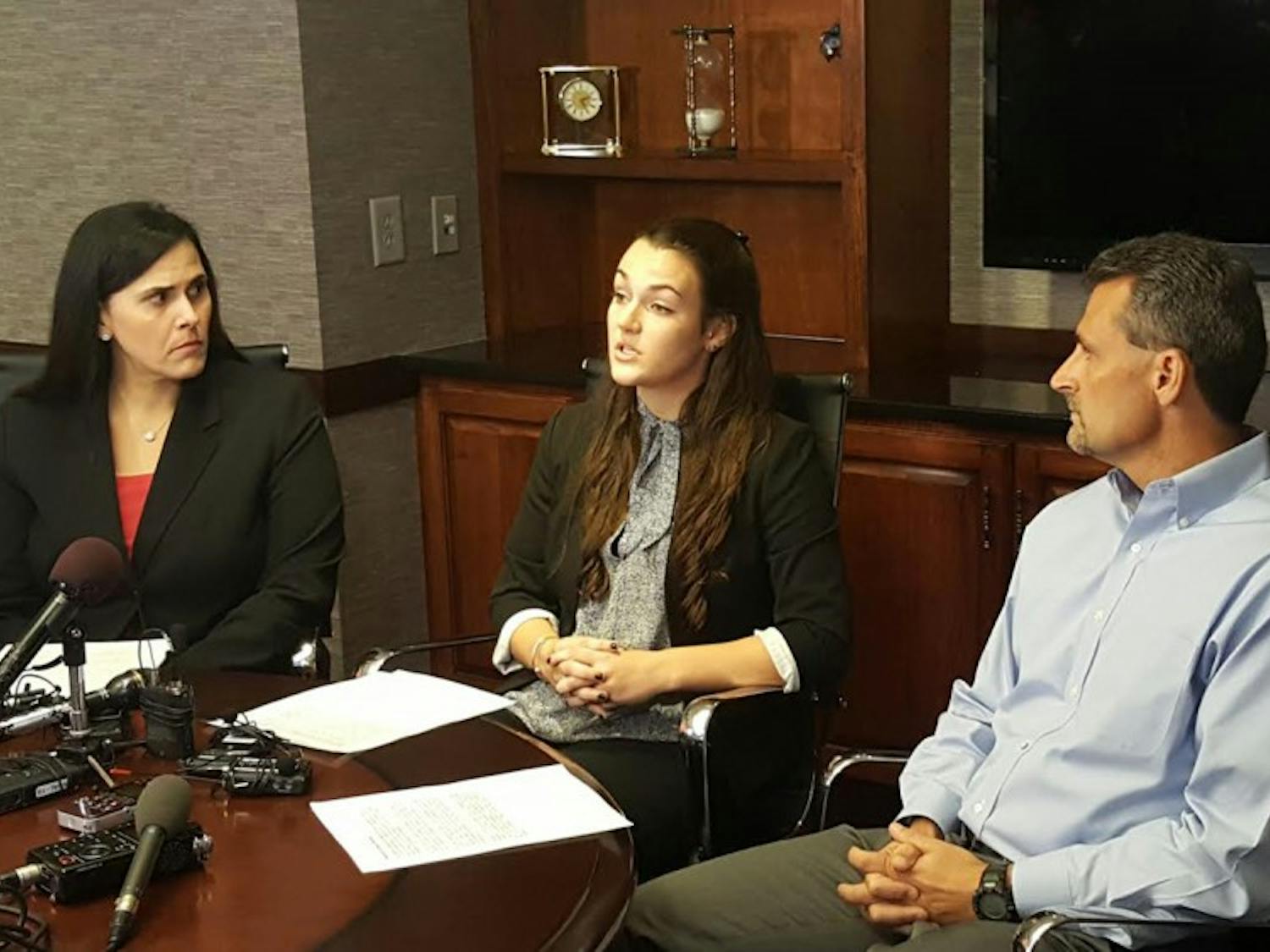Delaney Robinson (center), with her attorney Denise W. Branch and her father, Stacey Robinson, earlier today at her press conference.&nbsp;