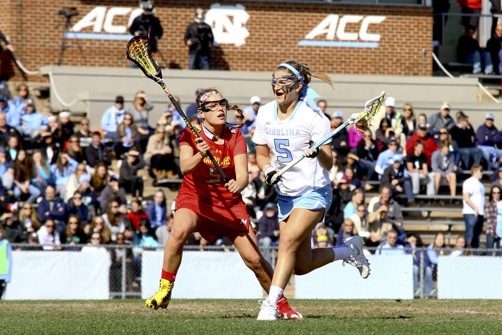 Olivi Ferrucci (5) runs past a Maryland defender Saturday afternoon. Ferrucci had two goals in the Tar Heels loss to the Maryland Terrapins. 