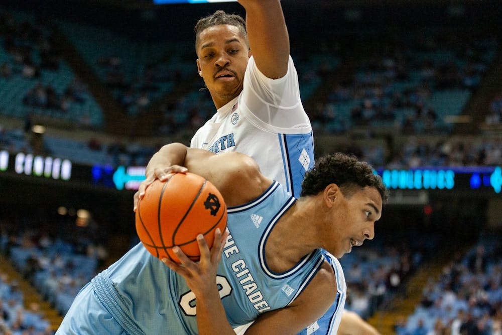 <p>UNC senior forward Armando Bacot (5) defends Citadel sophomore forward Jackson Price (0) during the men's basketball game against The Citadel at the Dean Smith Center on Tuesday, Dec. 13, 2022. UNC beat The Citadel 100-67.</p>