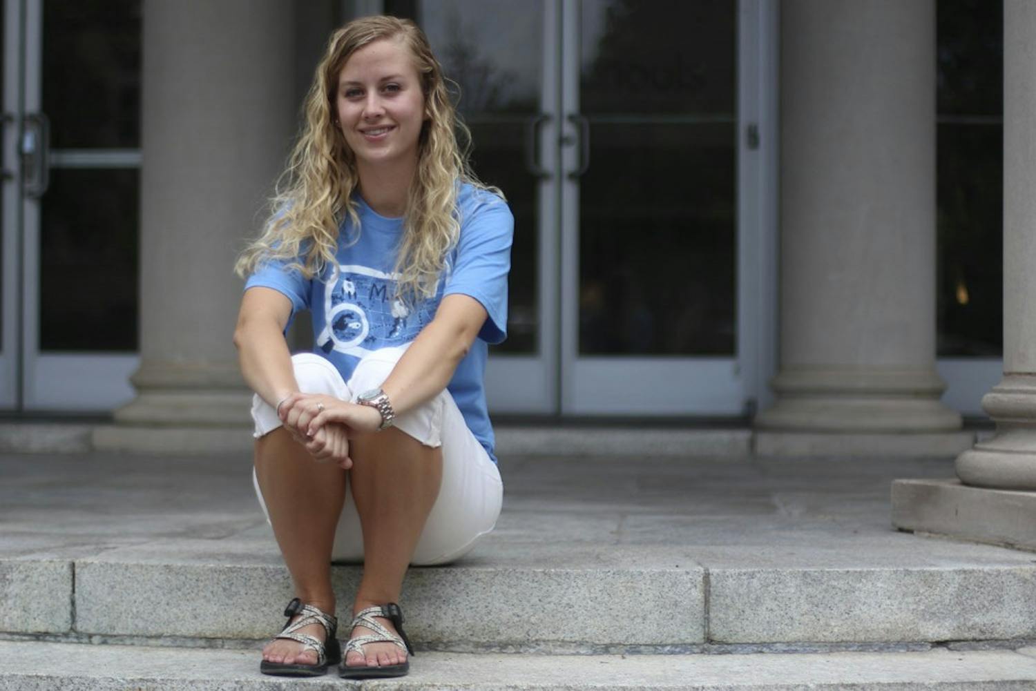 Ashley Shaver, an elementary education student, sits on the step of Peabody, the academic building for the School of Education.