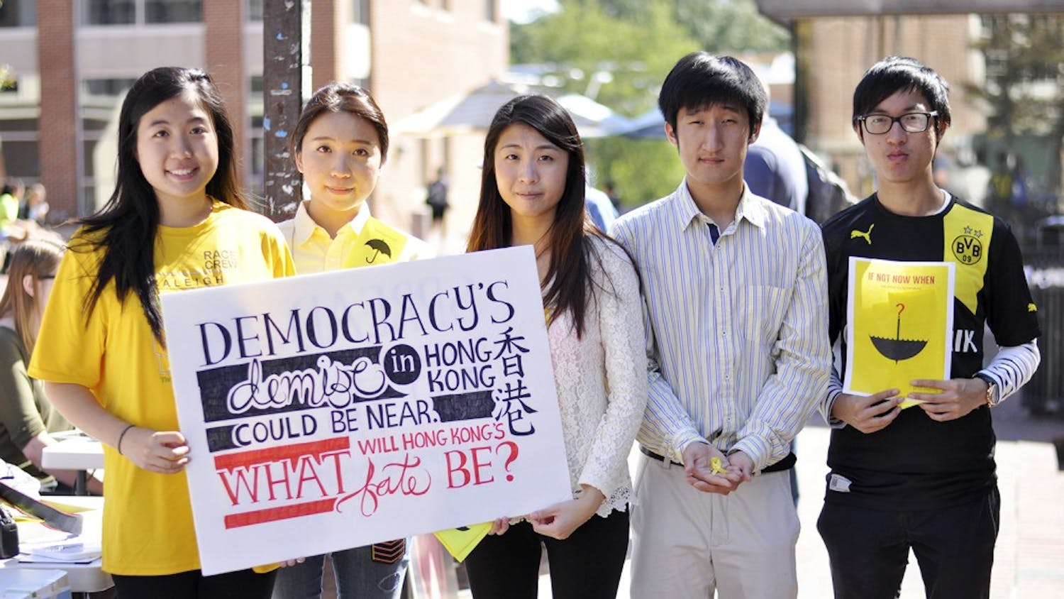 From left to right, Sam Lin, Kathleen Cheng, Christie Leung, Tim Kang, and Kiko Wong stand together to support Hong Kong, sponsored by the Asian Students Association at UNC. Christie and Kiko are students from Hong Kong studying at UNC through the GLOBE program, Sam and Tim are students at UNC and members of the Asian Students Association, and Kathleen graduated from UNC with the Class of 2014.
