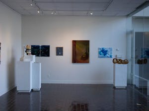 The senior BFA and BA exhibition titled 'Intersecting Realms' is seen in the John and June Allcott Gallery in Hanes Art Center on Wednesday, April 19, 2023. The exhibit is on display from April 17 until May 13, and it features seminar works from studio art seniors in ARTS 500.