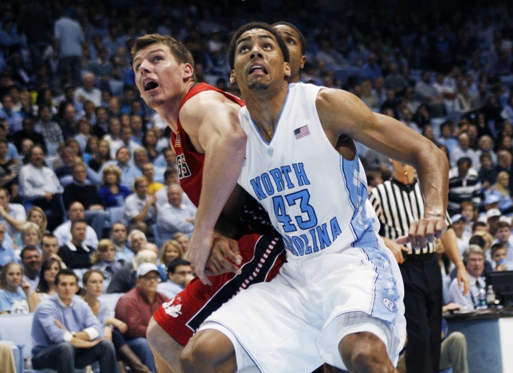 	<p>James Michael McAdoo boxes out a Gardner-Webb player for a rebound.</p>