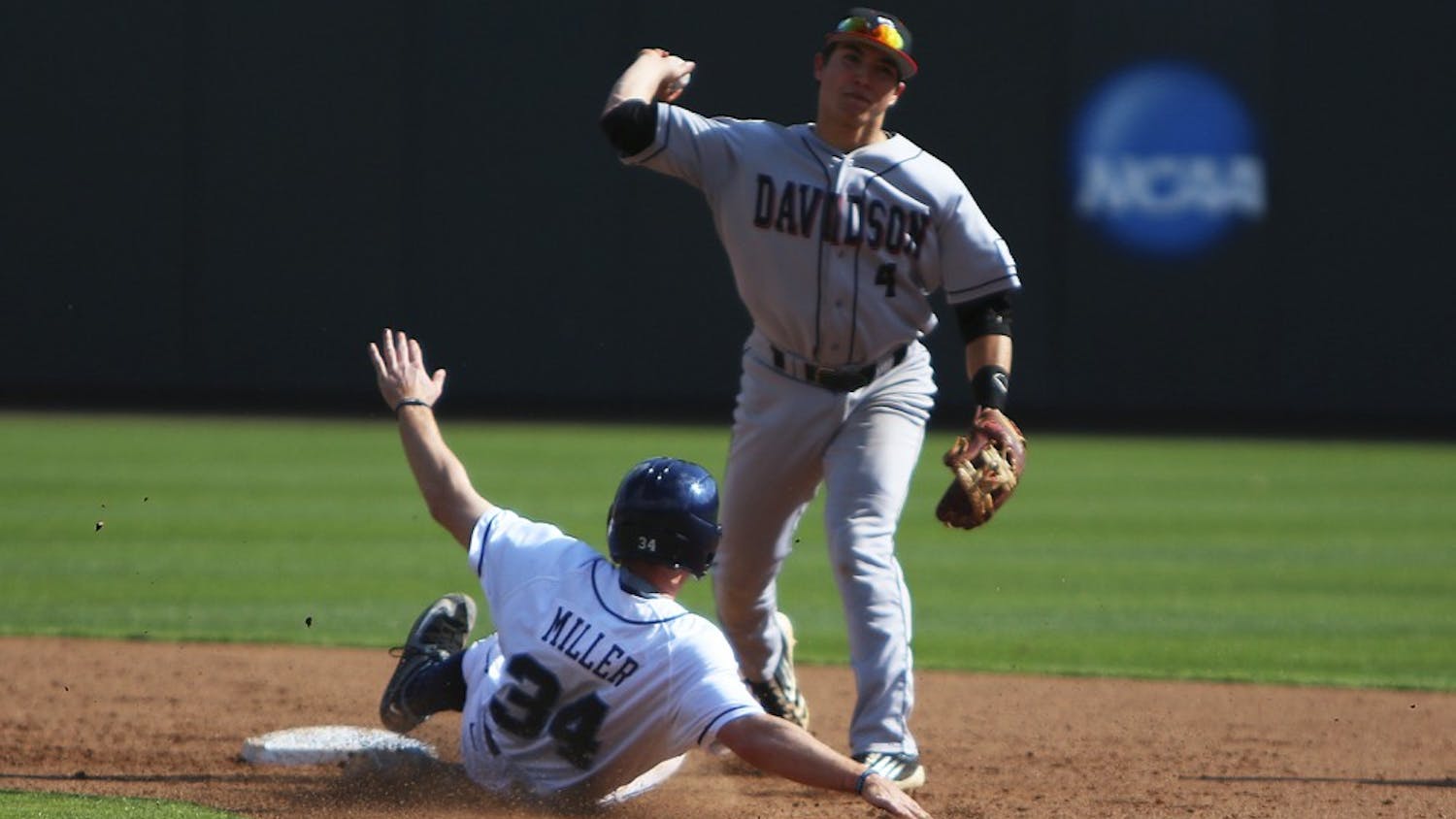 Left fielder Brian Miller (34) slides into second base where he is tagged out.