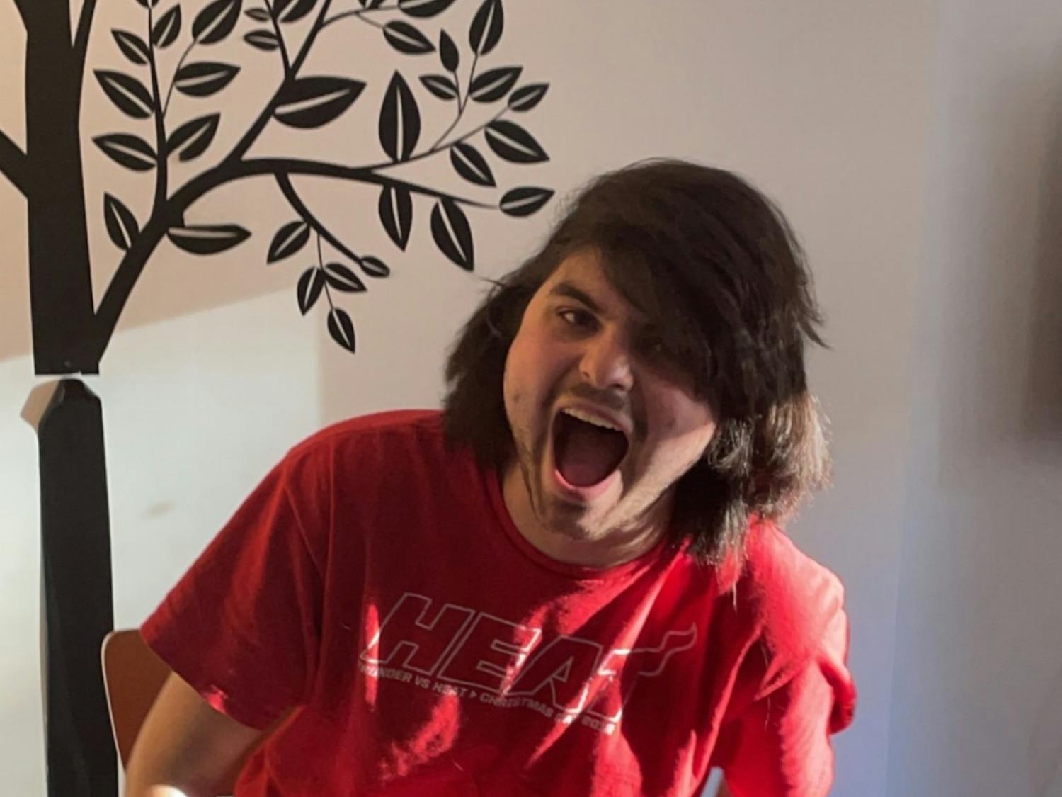 Guillermo Molero is pictured screaming in the flat he stayed in while studying abroad in London, with his signature curly hair straightened for the bit, on Saturday, April 9, 2022.&nbsp;