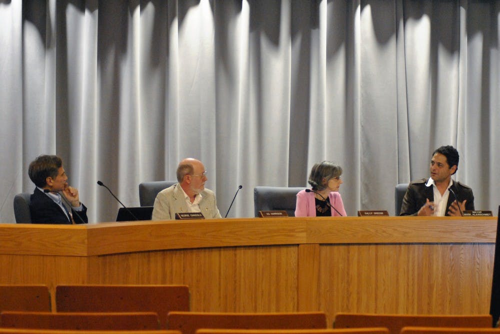 Council members George Cianciolo, Ed Harrison, Sally Greene, and Mayor  Mark Kleinschmidt discuss the agenda for the meeting.