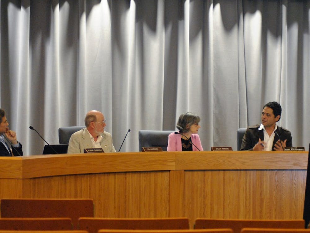 Council members George Cianciolo, Ed Harrison, Sally Greene, and Mayor  Mark Kleinschmidt discuss the agenda for the meeting.