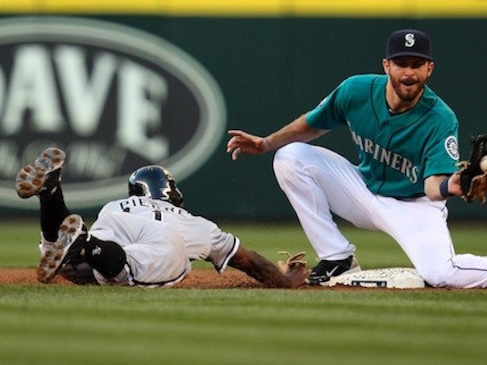 The Chicago White Sox's Juan Pierre, left, gets back to second base on a pickoff play to the Seattle Mariners' Dustin Ackley in the first inning at Safeco Field in Seattle, Washington, Friday, August 26, 2011. The White Sox defeated the Mariners, 4-2. (Jim Bates/Seattle Times/MCT)