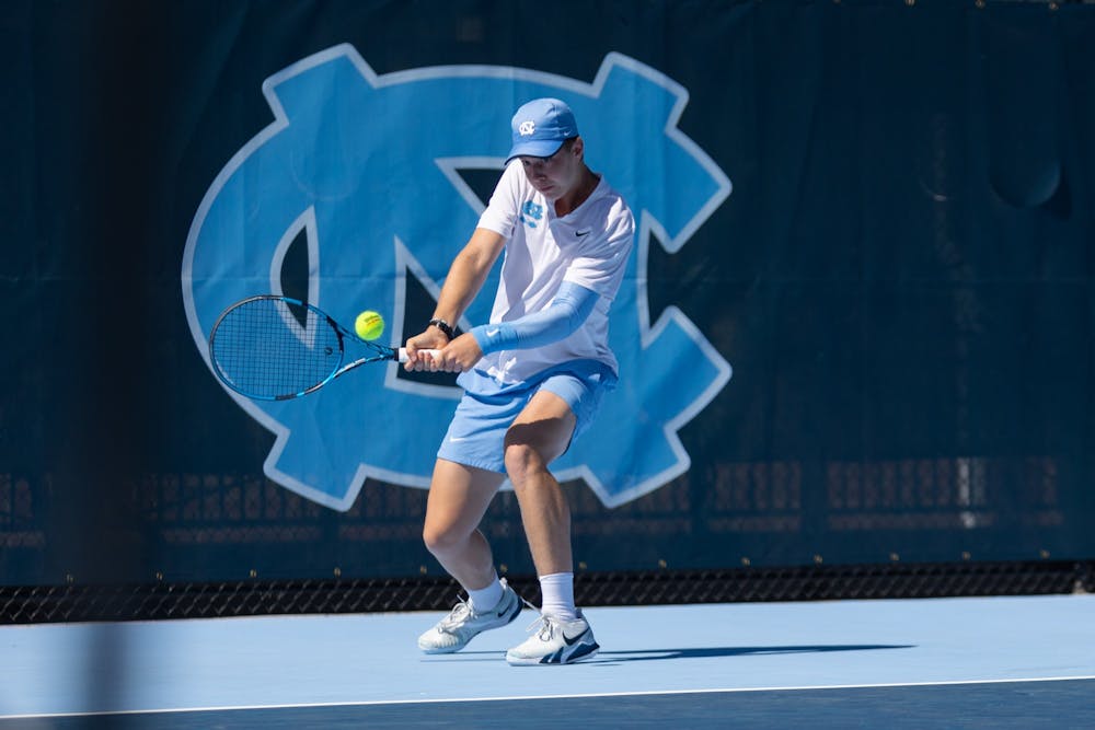 <p>UNC first-year Will Jansen returns a volley during the men's tennis match against Wake Forest at the newly opened Cone-Kenfield Tennis Center in Chapel Hill on Sunday, April 2, 2023. UNC beat Wake Forest 4-3.</p>