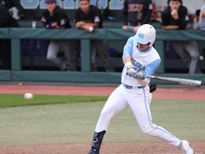 UNC redshirt sophomore outfielder Angel Zarate (42) offers at a pitch during the Tar Heels' game against East Carolina University at Boshamer Stadium on March 23, 2021. The Tar Heels defeated the Pirates 8-1.