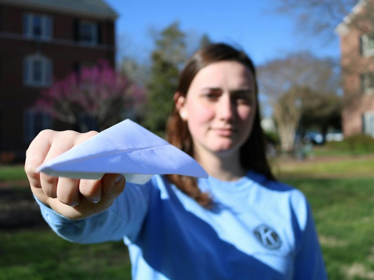 Sophomore Sara Lafontaine holds up a paper airplane on Tuesday, March 26, 2019. The Residence Hall Association is hosting The Big Paper Airplane Tournament on Saturday, March 30, 2019 at 2 PM at the Connor Quad. The event is designed to raise awareness about sustainable practices. Free food and giveaways will be available to those who attend. 