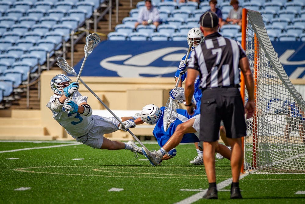 UNC senior midfielder William Perry (3) takes a shot on goal during the Tar Heels' 15-12 victory against Duke on Sunday, May 2. With the victory, UNC and Duke share the 2021 ACC regular season title.