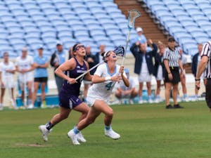 North Carolina women's lacrosse midfielder Marie McCool (4) reaches to catch the ball during Saturday's NCAA quarterfinal win against Northwestern.&nbsp;