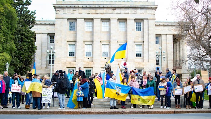 People gather outside of the North Carolina State Capitol building in Raleigh, N.C. for a march in support of Ukraine on Feb. 26, 2022.