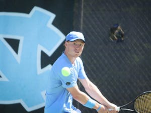 Senior Mac Kiger stares down the ball, ready to return it with a forehand swing during his singles match. UNC beat Georgia Tech 7-0 on Sunday, April 3, 2022.