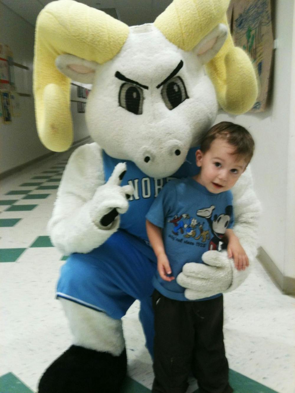 	Cooper Herman poses with UNC mascot Ramses. The Hermans have raised thousands of dollars for families with children battling cancer. Courtesy of Justin and Elise Herman