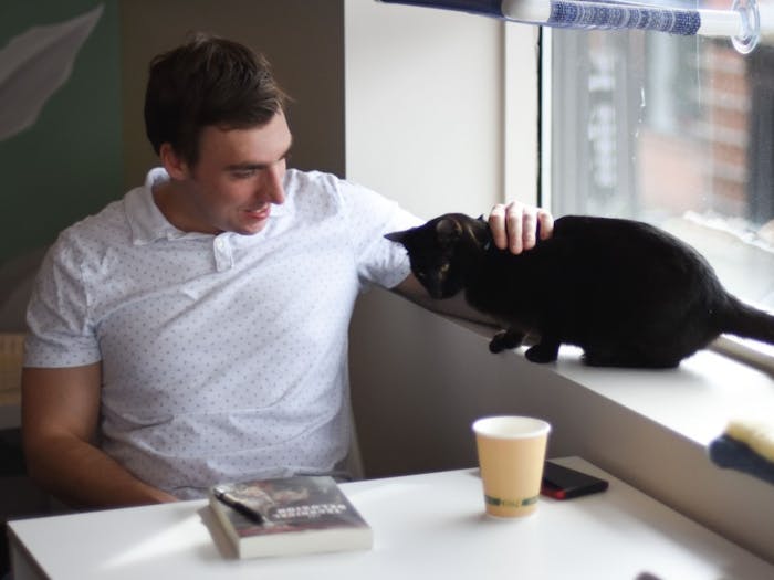 Bo Eberle, &nbsp;a UNC graduate who lives in Carrboro, says he came to the Cat Tales Cat Cafe on Friday, Feb. 15, 2019 because he's "an aspiring crazy cat guy."