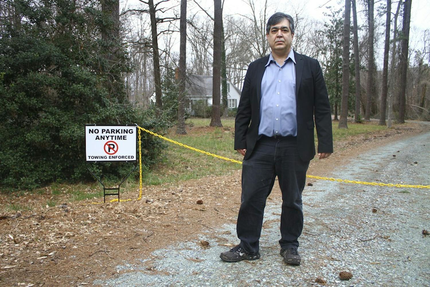 Eric McAfee, Chapel Hill resident, stands at the entrance of his former driveway. 
