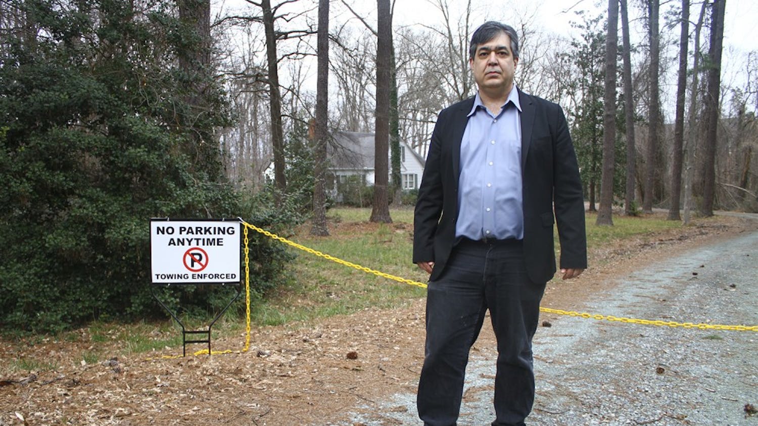 Eric McAfee, Chapel Hill resident, stands at the entrance of his former driveway. 
