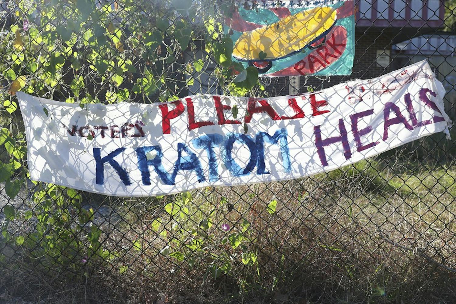 A banner calling for voters to not outlaw kratom&nbsp;hangs on a fence on the corner&nbsp;N. Greensboro St.and E. Weaver St.