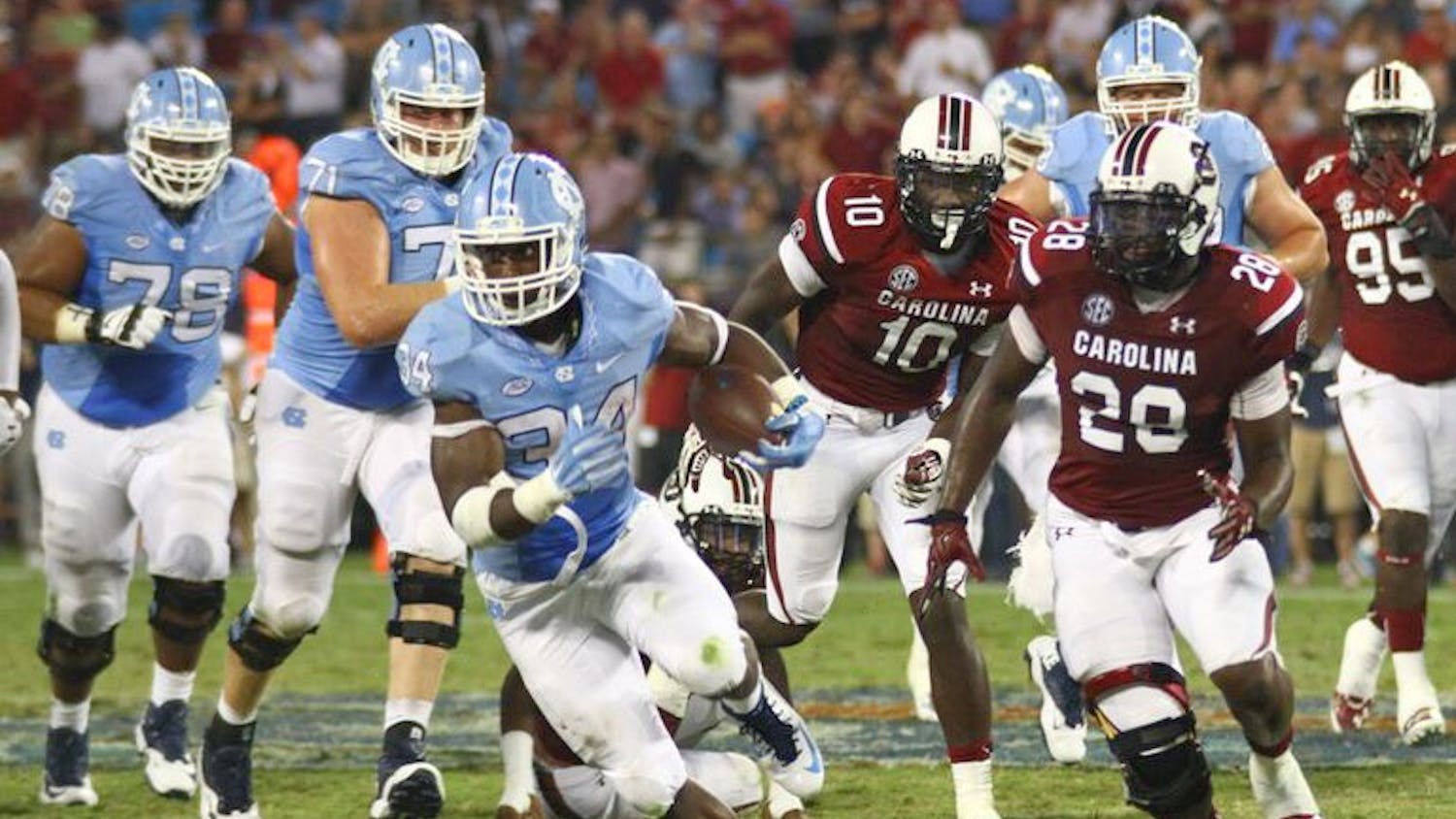 Elijah Hood (34) carries the ball during UNC’s game against USC in Charlotte.
